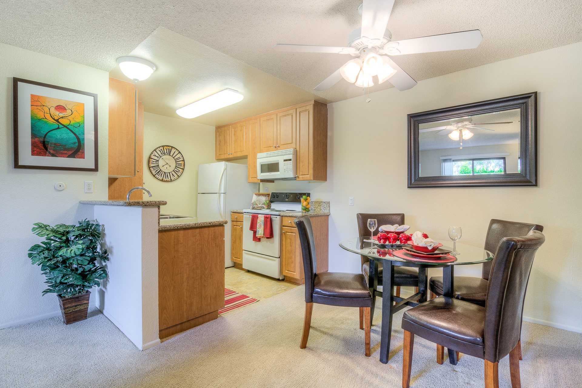 A kitchen with a dining table and chairs.,A kitchen with a dining table and chairs.